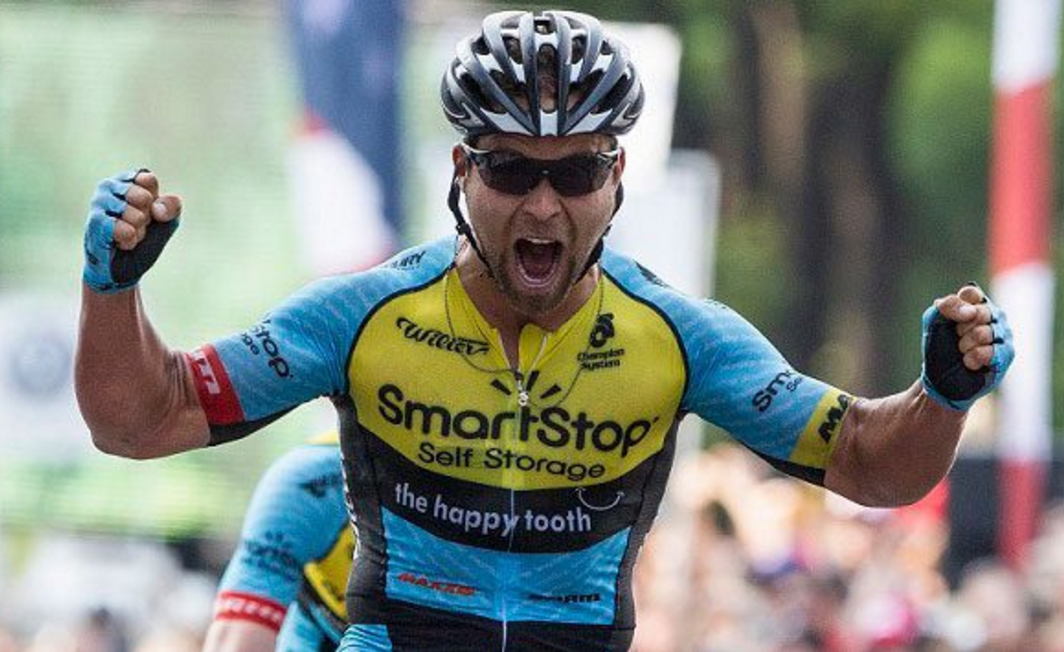 cyclist wearing sunglasses cheering