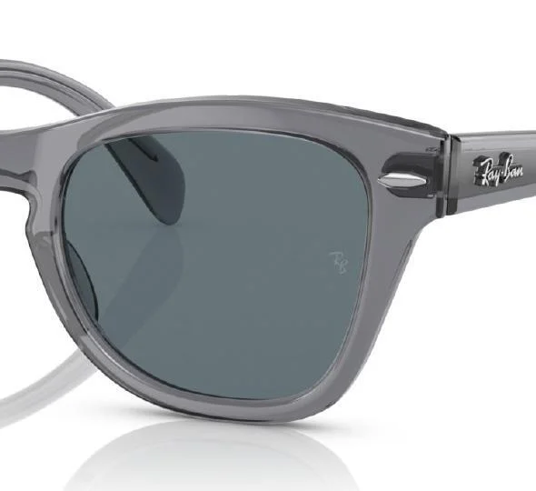 Close-up of the Ray-Ban RB0707S Sunglasses, showcasing their gray acetate frame and dark lenses, with the iconic Ray-Ban logo displayed on the side.